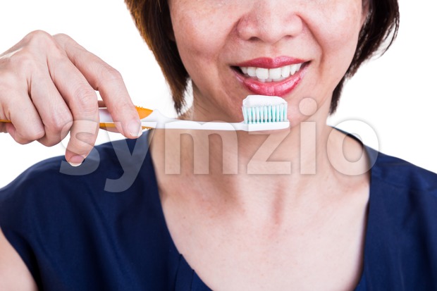 Asian women with beautiful teeth holding toothbrush and toothpaste Stock Photo