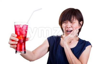 Focus on ice cold drink with women with toothache background Stock Photo