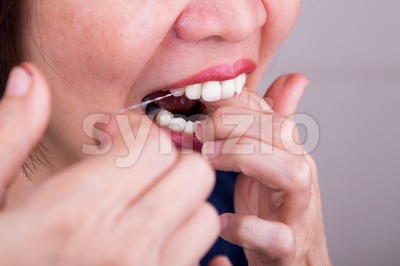 Series of Asian woman flossing teeth with oral floss Stock Photo