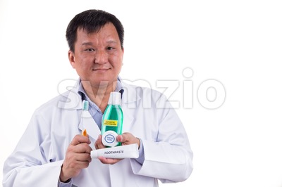 Dentist recommend tapered bristle toothbrush, toothpaste, mouthwash, and dental floss Stock Photo