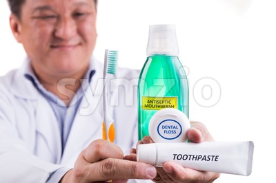 Dentist recommend tapered bristle toothbrush, toothpaste, mouthwash, and dental floss Stock Photo
