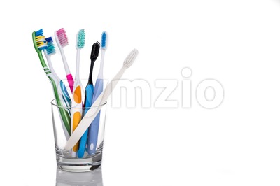 Toothbrushes with different head and bristle design placed in glass Stock Photo