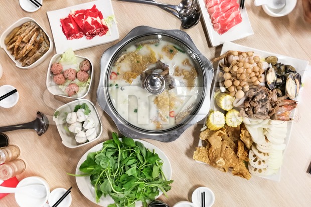 Traditional Chinese steamboat or hotpot with delicious food spread Stock Photo