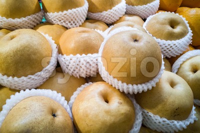 Whole yellow nashi pear wrapped in protective foam Stock Photo