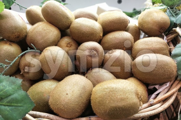 Whole natural organic Kiwi fruit in basket Stock Photo