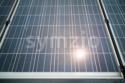 Closeup on solar panels with reflection of the sun Stock Photo