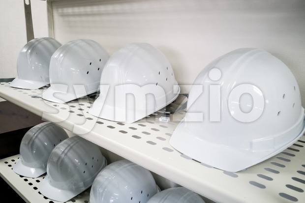 Industrial white safety helmet storage in factory Stock Photo