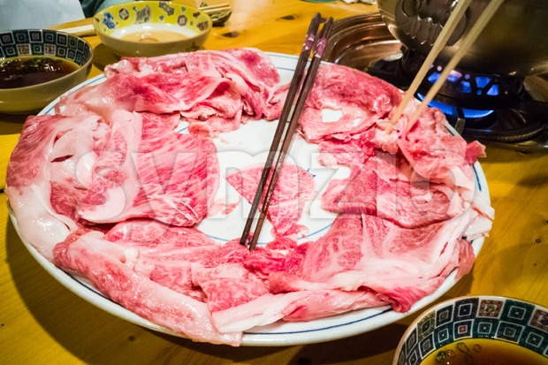 People dining with raw Japanese kobe beef shabu-shabu steamboat Stock Photo