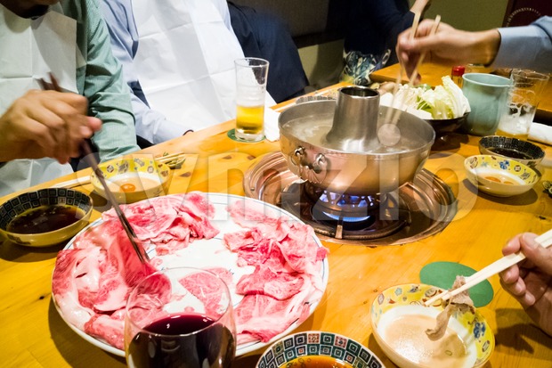 People dining with raw Japanese kobe beef shabu-shabu steamboat Stock Photo