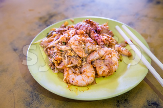 Penang Char Kuey Teow or fried noodle with big prawns Stock Photo