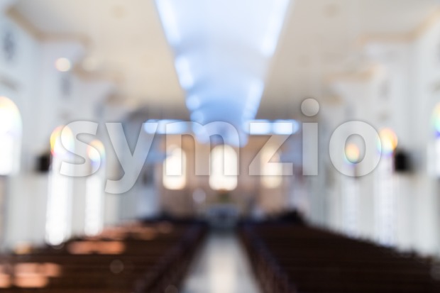 Defocused interior of Catholic church with pews Stock Photo