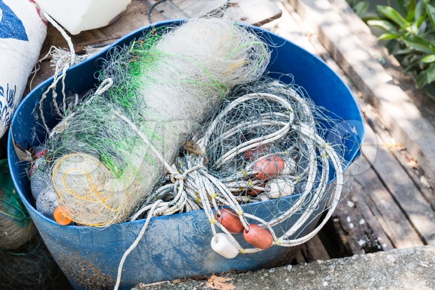 Traditional fisherman net, float and rope folded up Stock Photo