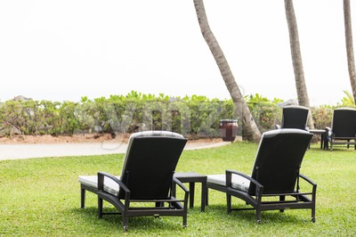 Relaxing deck chairs at tropical resort with nobody Stock Photo