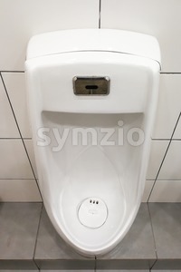 Modern clean hygienic men urinal ware in public washroom toilet Stock Photo