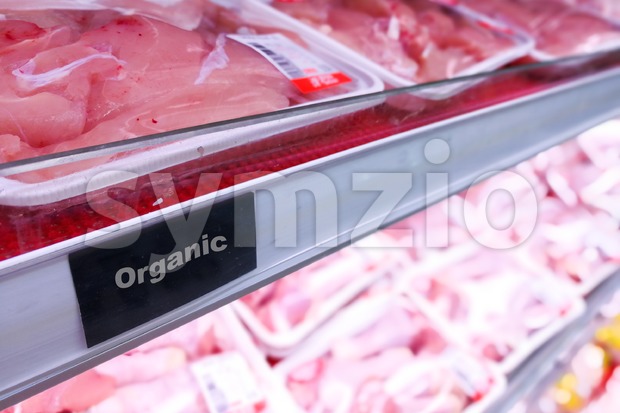 Organic food signage on modern supermarket fresh chilled meat aisle Stock Photo