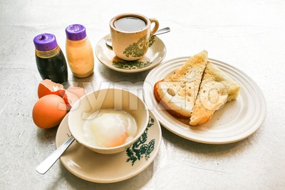 Asian traditional breakfast half boiled eggs, toast bread and coffee Stock Photo
