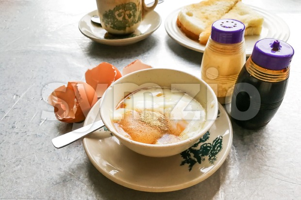 Asian traditional breakfast half boiled eggs, toast bread and coffee Stock Photo