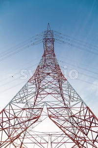 Perspective view under a huge red electricity supply pylon Stock Photo