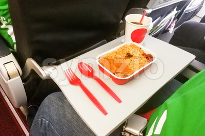 Simple in-flight meal of rice, meat, coffee in disposable utensils Stock Photo