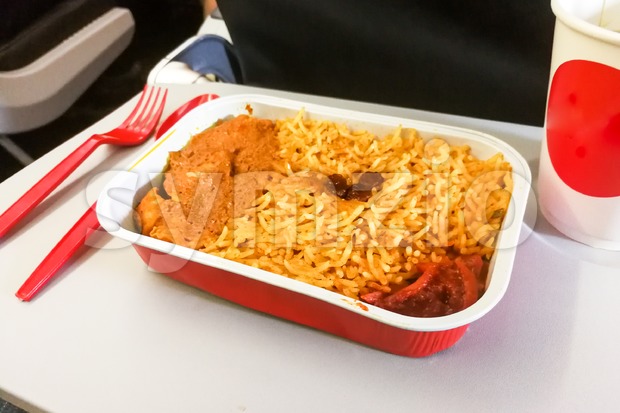 close-up simple in-flight meal rice, meat, coffee in disposable utensils Stock Photo