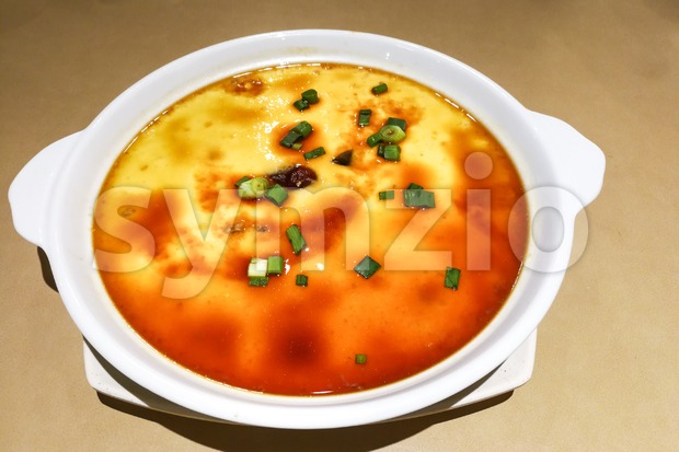 Plate of fresh Chinese Steamed Eggs with scallion Stock Photo