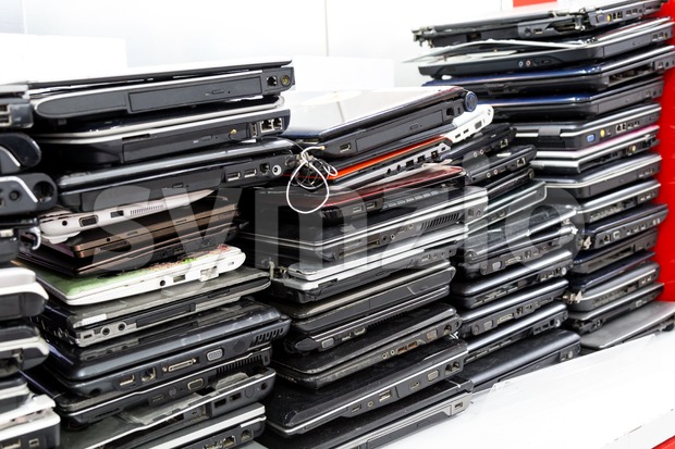 Stack of old, broken and obsolete laptop computer for repair Stock Photo