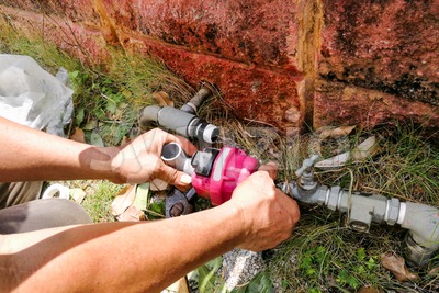 Series of plumber fixing installing oudoor valve meter piping Stock Photo