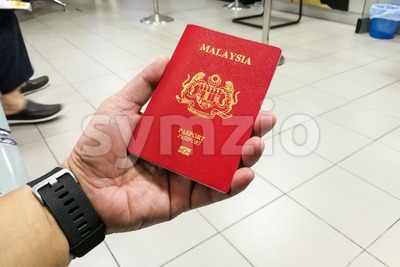 Person holding Malaysia international passport Stock Photo