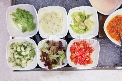 Healthy appetizing vegetable breakfast organic salad, tomato, onion, cucumber, dressing Stock Photo