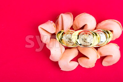 Fortune cookies with decorative gold nuggets on red background Stock Photo