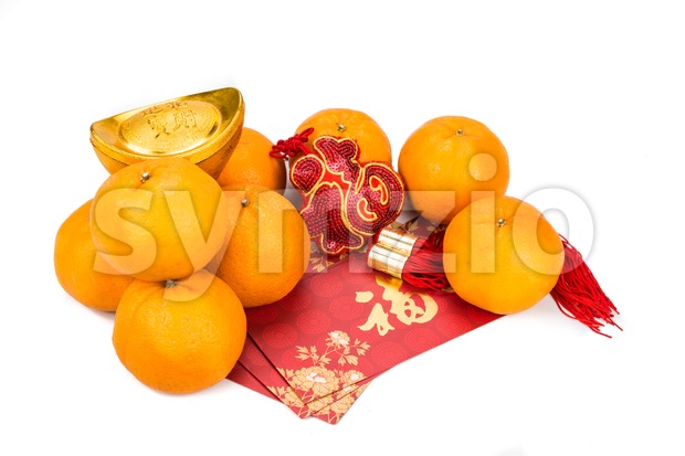 Mandarin oranges, gold nuggets, red packets with good luck character Stock Photo
