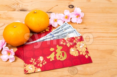 Red packet with Good Fortune character contains US Dollar notes Stock Photo