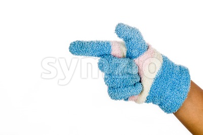 Hand in blue winter glove pointing direction against white background. Stock Photo