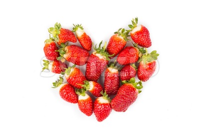 Heaps of strawberries form heart shape on white background Stock Photo