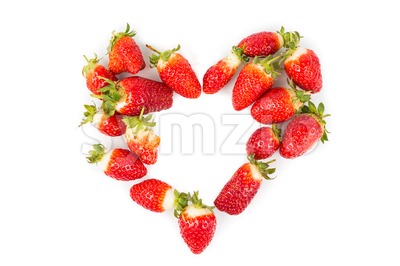 Heaps of strawberries form heart shape on white background Stock Photo