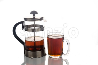 Freshly brewed hot tea in transparent glass with portafilter Stock Photo