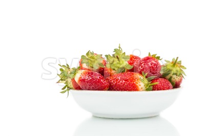 Plateful of freshly harvested organic strawberries with white background Stock Photo