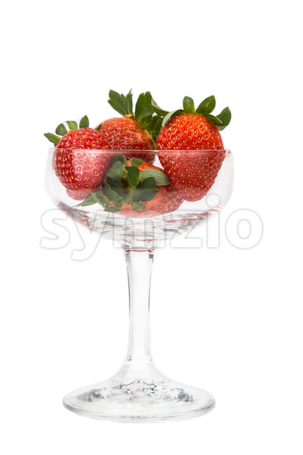 Juicy strawberries in a transparent cocktail glass with white background Stock Photo