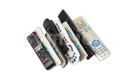 Stack of audio video remote control device in white background Stock Photo